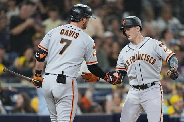 Aug 31, 2023; San Diego, California, USA; San Francisco Giants right fielder Mike Yastrzemski (right) is congratulated by third baseman J.D. Davis (7) after hitting a home run against the San Diego Padres during the fifth inning at Petco Park.