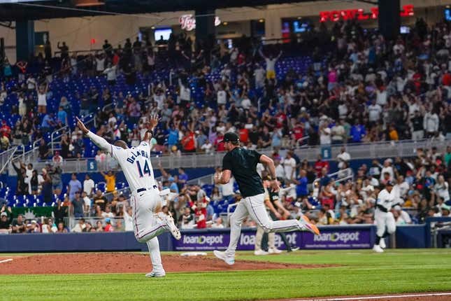 May 31, 2023; Miami, Florida, USA; Miami Marlins left fielder Bryan De La Cruz (14) runs onto the field after defeating the San Diego Padres at loanDepot Park.