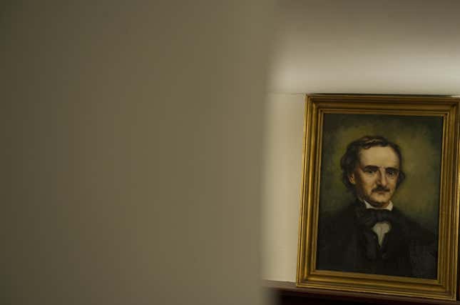 A portrait of US author Edgar Allan Poe hangs on a wall.