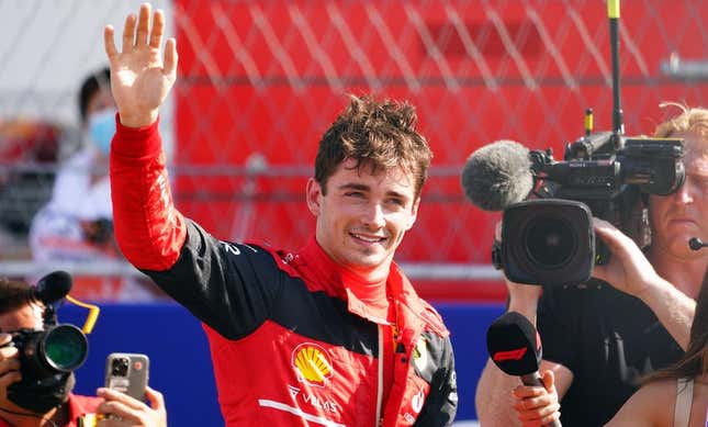 May 7, 2022; Miami Gardens, Florida, USA; Ferrari driver Charles Leclerc of Monaco waves to the fans in the stands after winning the pole position following qualifying for the Miami Grand Prix at Miami International Autodrome.