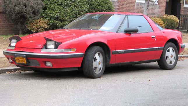 A photo of a red Buick Reatta sports car. 