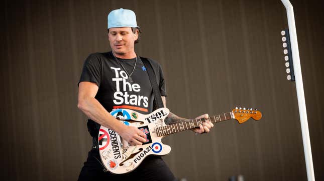 Tom DeLonge performing in his UFO research organization’s t-shirt