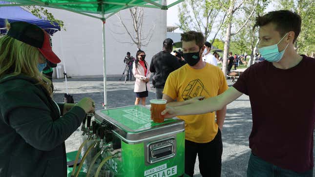  Newly vaccinated people enjoy a free beer after getting their coronavirus shots during a walk-up clinic at the Kennedy Center’s outdoor Reach area on May 06, 2021 in Washington, DC.