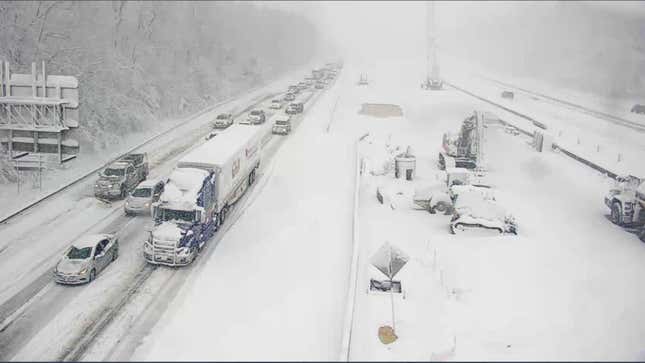 A closed section of Interstate 95 near Fredericksburg, Virginia with cars and trucks stranded on a snowy roadway.