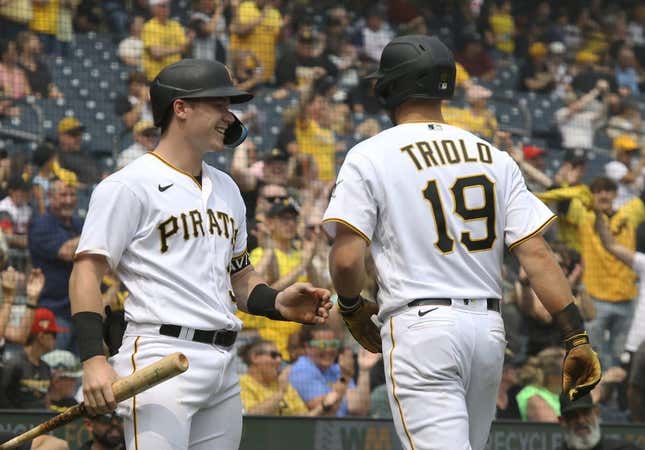 Jun 29, 2023; Pittsburgh, Pennsylvania, USA; Pittsburgh Pirates right fielder Henry Davis (left) congratulates third baseman Jared Triolo (19) after Triolo scored a run on a San Diego Padres error during the seventh inning at PNC Park. Pittsburgh won 5-4.