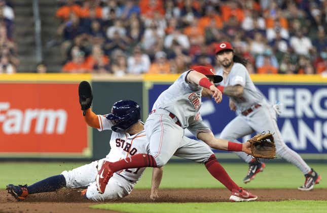 Jun 17, 2023; Houston, Texas, USA; Houston Astros second baseman Jose Altuve (27) steals second base against Cincinnati Reds shortstop Matt McLain (9) n the first inning at Minute Maid Park.