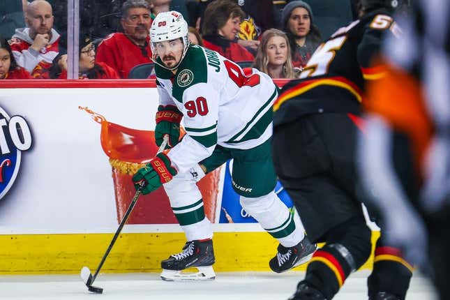 Mar 4, 2023; Calgary, Alberta, CAN; Minnesota Wild left wing Marcus Johansson (90) controls the puck against the Calgary Flames during the third period at Scotiabank Saddledome.