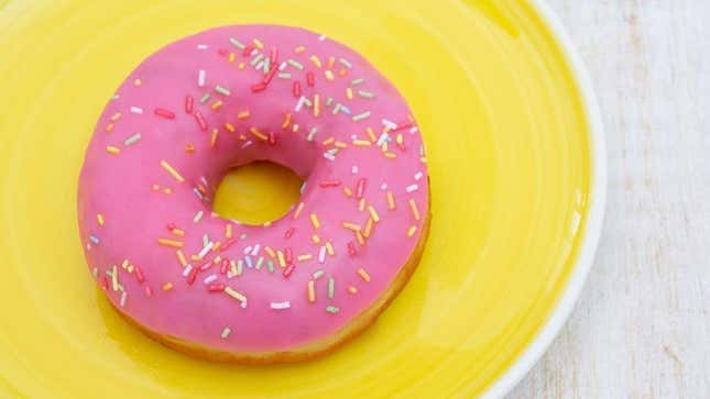 Pink doughnut on yellow plate
