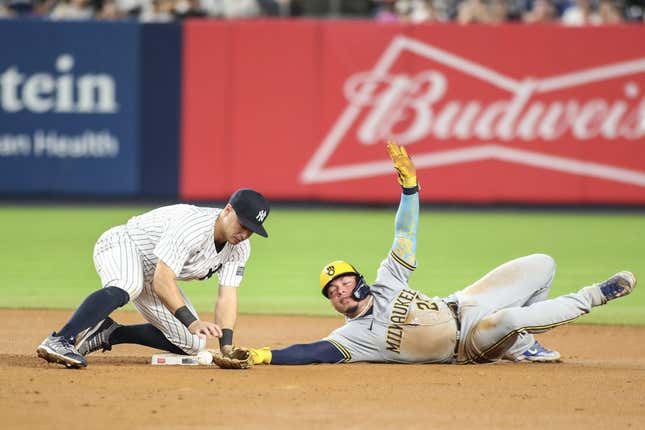 Sep 8, 2023; Bronx, New York, USA;   New York Yankees shortstop Anthony Volpe (11) drops the ball allowing Milwaukee Brewers catcher William Contreras (24) to steal second in the seventh inning at Yankee Stadium.