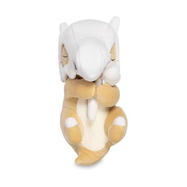 A Cubone plush shows the Pokemon sleeping with its bone wrapped in its arms.
