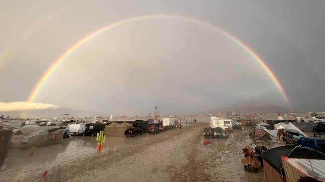 An image shows a rainbow seen over the muddy grounds of the “Burning Man” festival. Tens of thousands of visitors to the desert festival Burning Man are stranded on the site after heavy rainfall over the weekend. 