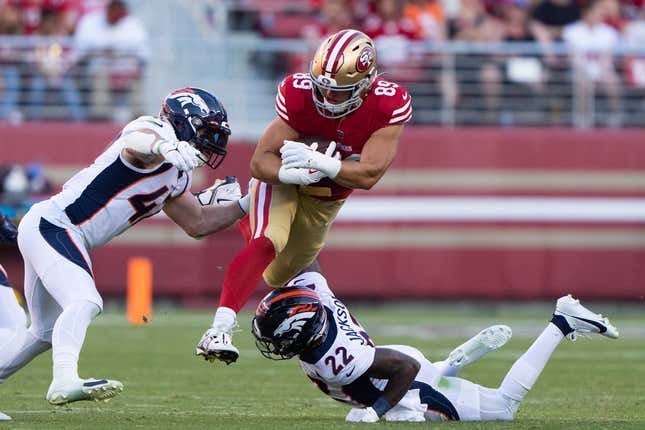 Aug 19, 2023; Santa Clara, California, USA;  San Francisco 49ers tight end Charlie Woerner (89) attempts to leap over Denver Broncos safety Kareem Jackson (22) and linebacker Josey Jewell (47) during the second quarter at Levi&#39;s Stadium.