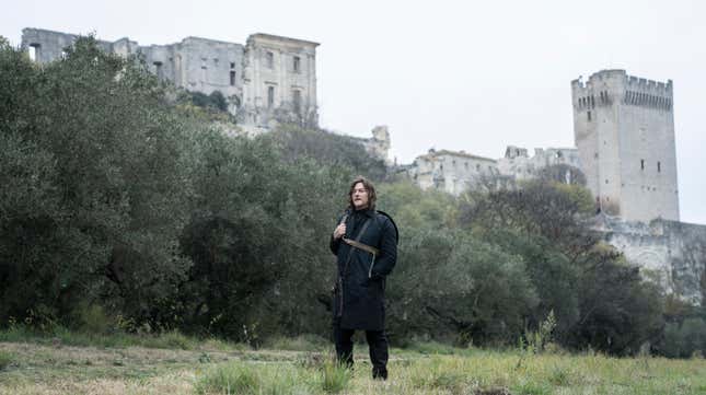 Norman Reedus as Daryl Dixon, standing in front of a castle on his Walking Dead spin-off