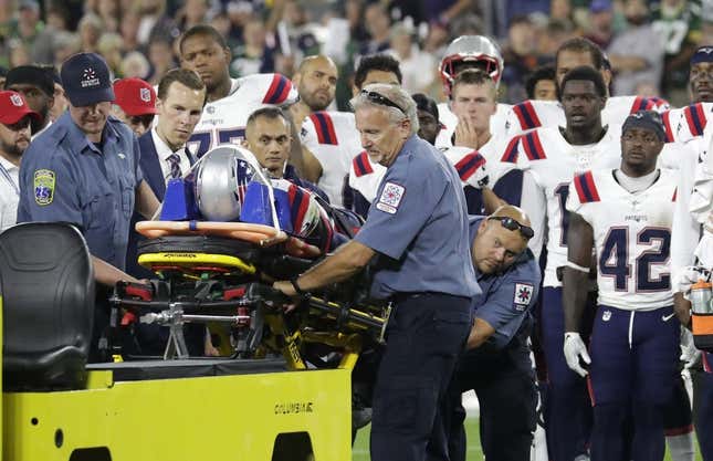 Aug 19, 2023; Green Bay, WI, USA;   Teammates look on as New England Patriots cornerback Isaiah Bolden (7) is taken off the field on a stretcher after a fourth quarter injury against the Green Bay Packers during their preseason football game at Lambeau Field. The game was suspended in the fourth quarter after the injury.