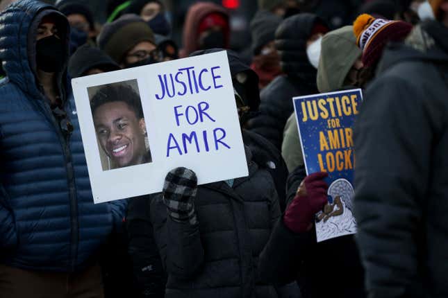 A protester holds a sign demanding justice for Amir Locke at a rally on Saturday, Feb. 5, 2022, in Minneapolis. Hundreds of people filled the streets of downtown Minneapolis after body cam footage released by the Minneapolis Police Department showed an officer shoot and kill Locke during a no-knock warrant.
