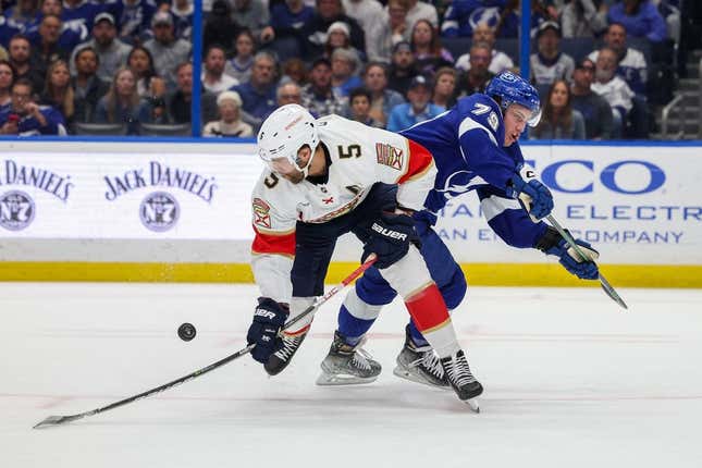 Feb 28, 2023; Tampa, Florida, USA;  Tampa Bay Lightning center Ross Colton (79) and Florida Panthers defenseman Aaron Ekblad (5) collide in the first period  at Amalie Arena.
