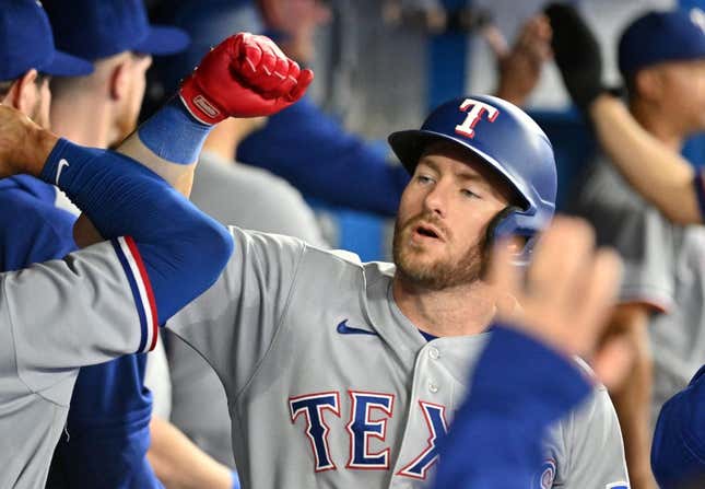 Sep 12, 2023; Toronto, Ontario, CAN;   Texas Rangers right fielder Robbie Grossman (4) celebrates with team mates in the dugout after hitting a two run home run against the Toronto Blue Jays in the fourth inning at Rogers Centre.