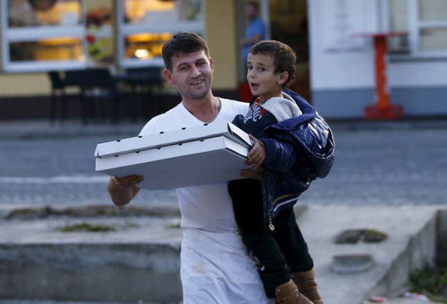 Image for article titled Photos: Hero Slovenian waiter delivers pizza to hungry migrant kids