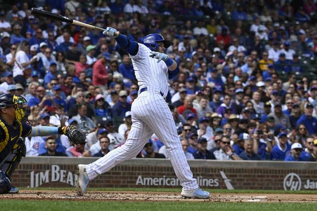 Aug 30, 2023; Chicago, Illinois, USA; Chicago Cubs left fielder Ian Happ (8) hits an RBI double against the Milwaukee Brewers during the first inning at Wrigley Field.