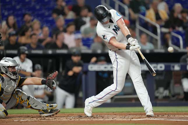 Jun 22, 2023; Miami, Florida, USA;  Miami Marlins first baseman Garrett Cooper (26) hits a double in the second inning against the Pittsburgh Pirates at loanDepot Park.