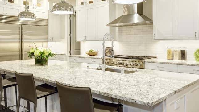 bright kitchen with white and grey granite countertops