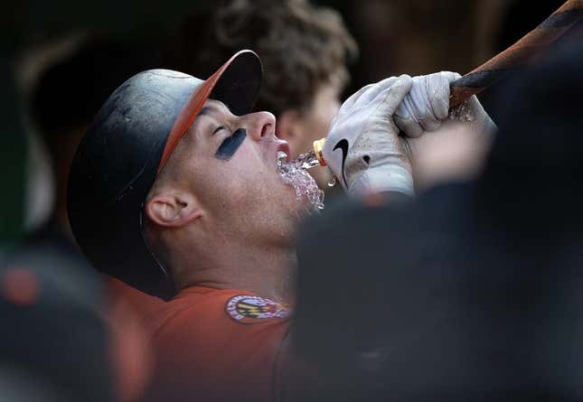Aug 19, 2023; Oakland, California, USA; Baltimore Orioles catcher James McCann gets a drink from the ceremonial funnel after hitting a home run against the Oakland Athletics during the fourth inning at Oakland-Alameda County Coliseum.