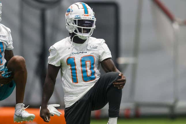Jun 6, 2023; Miami Gardens, FL, USA; Miami Dolphins wide receiver Tyreek Hill (10) stretches during mandatory minicamp at the Baptist Health Training Complex.