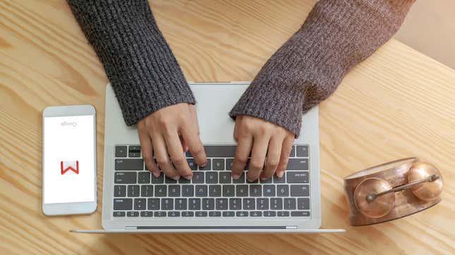 Person writing on laptop 