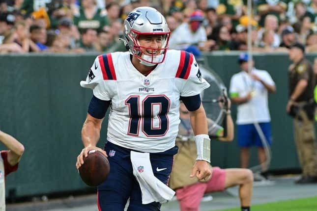 Aug 19, 2023; Green Bay, Wisconsin, USA; New England Patriots quarterback Mac Jones (10) reacts after the Patriots scored a touchdown against the Green Bay Packers at Lambeau Field.
