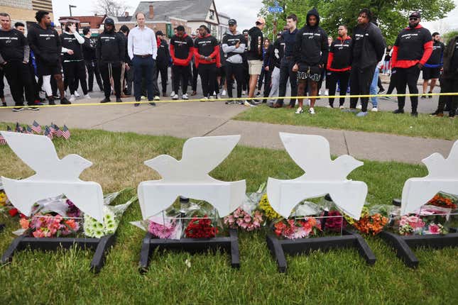 Members of the Buffalo Bills lay flowers at a memorial near the Tops supermarket where ten people were killed last Saturday on, May 18, 2022, in Buffalo, New York.