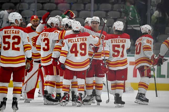 Mar 6, 2023; Dallas, Texas, USA; Calgary Flames right wing Tyler Toffoli (73) and the Flames celebrate on the ice after the Flames defeat the Dallas Stars at the American Airlines Center.