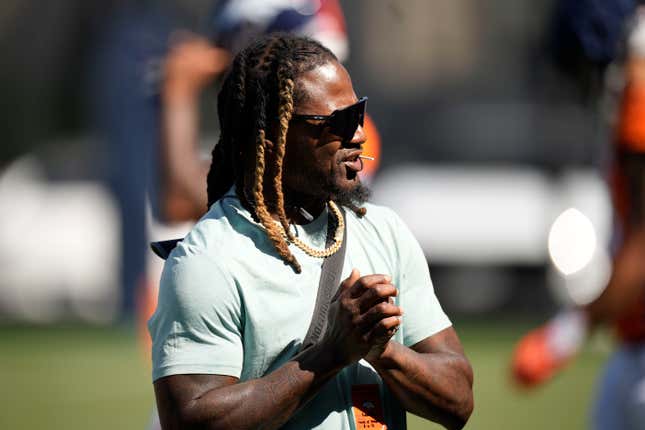 Retired NFL cornerback Adam "Pacman" Jones looks on as players take part in drills during training camp