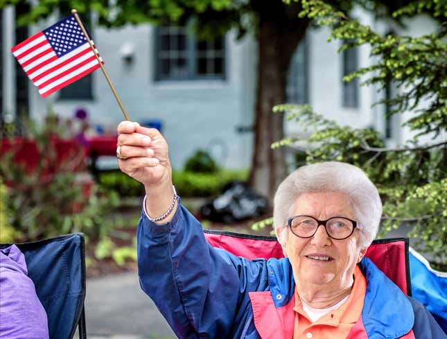 Image for article titled Old Lady At Parade Flapping Little American Flag Like A Motherfucker