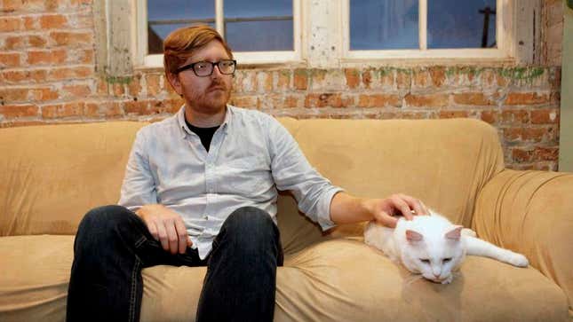 Image for article titled Frustrated Man Doesn’t Know What Else He Can Do To Get Cat Purring