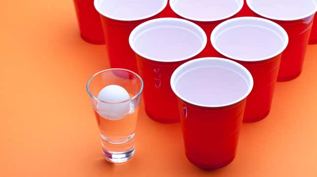 Beer pong cups and ball on table