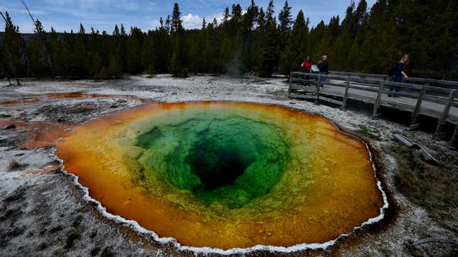 Tourists view the Morning Glory hot spring in the Upper Geyser Basin of Yellowstone National Park in Wyoming.