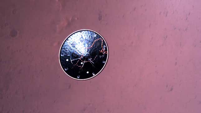 The ejected heat shield falling towards the surface. 