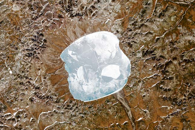Natural-color satellite image of Lake El’gygytgyn, which sits inside a small asteroid impact crater in eastern Russia near the Arctic Circle. The impact crater is around 3.6 million years old.