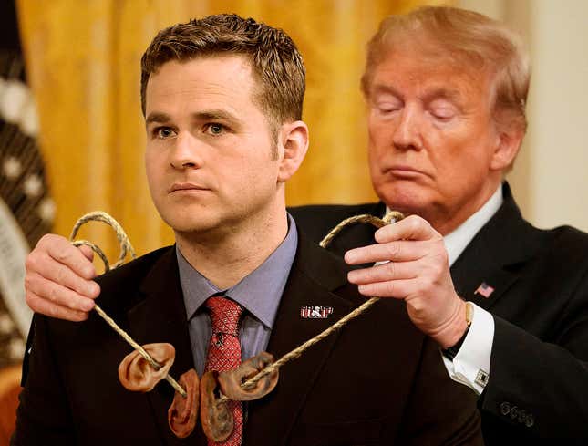 Image for article titled Trump Honors War Criminal With Presidential String Of Human Ears