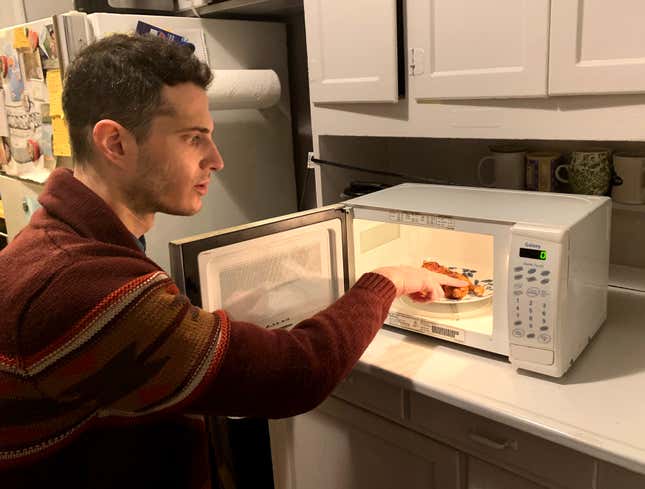 Image for article titled Man Checking If Chicken Wings Got Hot Enough In Microwave Like First Responder Searching For Pulse