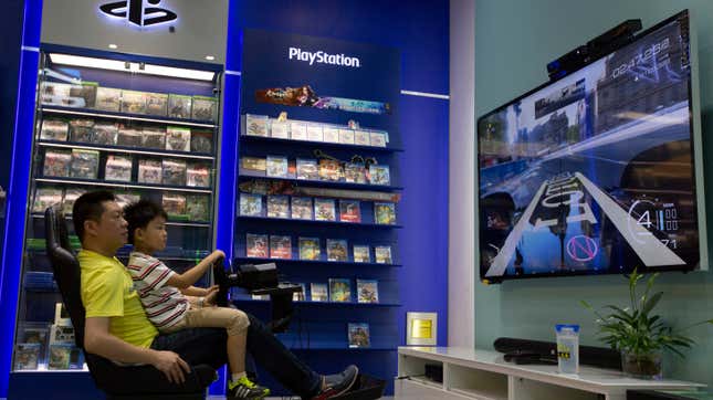 A sales person assisting a young customer at a game store in Beijing.