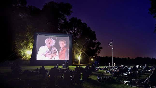 Image for article titled Outdoor Movie Guest Excited To Watch Barely Audible ‘Back To The Future’ While Sitting On Tree Root