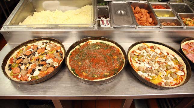 deep dish pizzas being prepared at restaurant