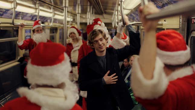 Austin Abrams and a whole bunch of Santas