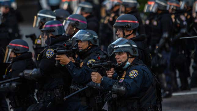 Police officers in Los Angeles wielding weapons during the recent protests against police brutality.