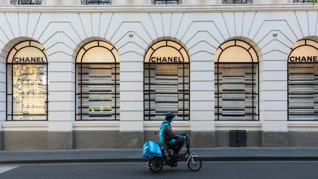 File photo of a food delivery rider driving past a Chanel store on October 26, 2020 in Melbourne, Australia.