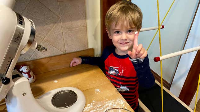 A little boy shows off a dollop of egg-free frosting
