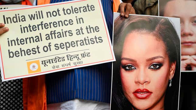 Activists of United Hindu Front (UHF) hold a placard and pictures of Swedish climate activist Greta Thunberg and Barbadian singer Rihanna during a demonstration in New Delhi on February 4, 2021, after they made comments on social media about ongoing mass farmers’ protests in India.