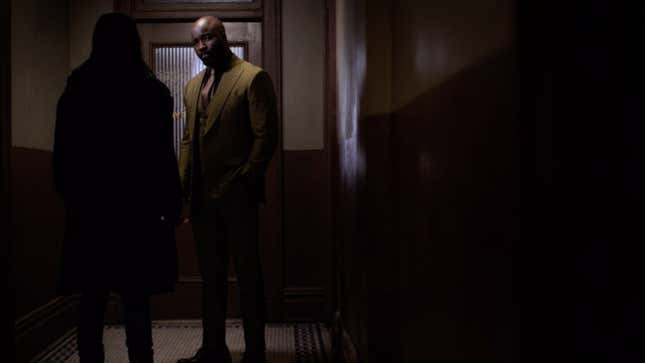Mike Colter as Luke Cage saying hello to Krysten Ritter as Jessica Jones.