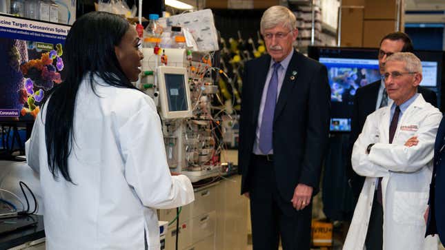 Dr. Kizzmekia Corbett, left, senior research fellow and scientific lead for coronavirus vaccines and immunopathogenesis team in the Viral Pathogenesis Laboratory, talks with President Donald Trump (not pictured) as he tours the Viral Pathogenesis Laboratory at the National Institutes of Health in Bethesda, Md.